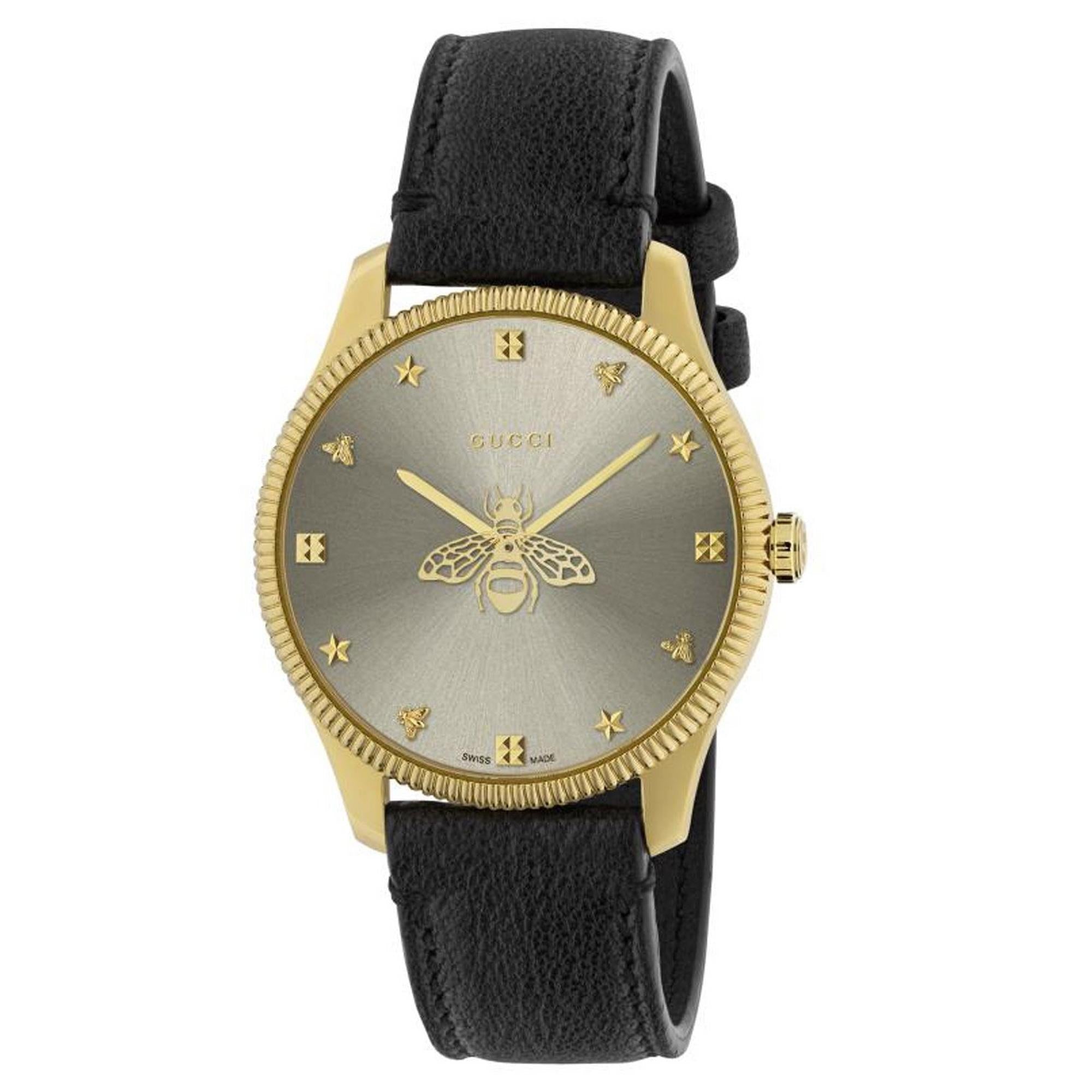 Elegant gold-toned ladies' Gucci G-Timeless watch with a black leather strap and bee-themed dial.